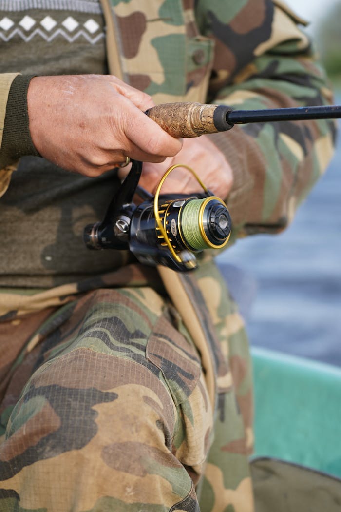 Offerings Close-up of a man fishing with rod in camouflage outfit, Jelgava, Latvia.